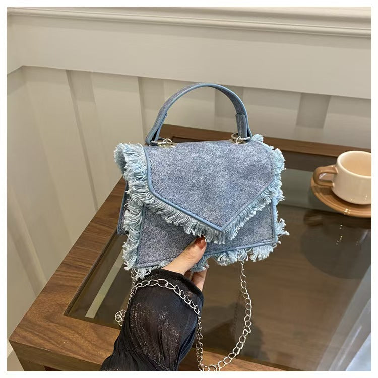 Model pairing Y2K Blue Bag with ripped jeans and neon streetwear