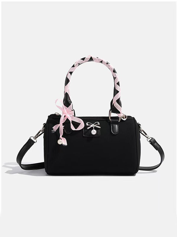 Y2K-inspired silk ribbon messenger bag with fluffy trim beside Ganni tote