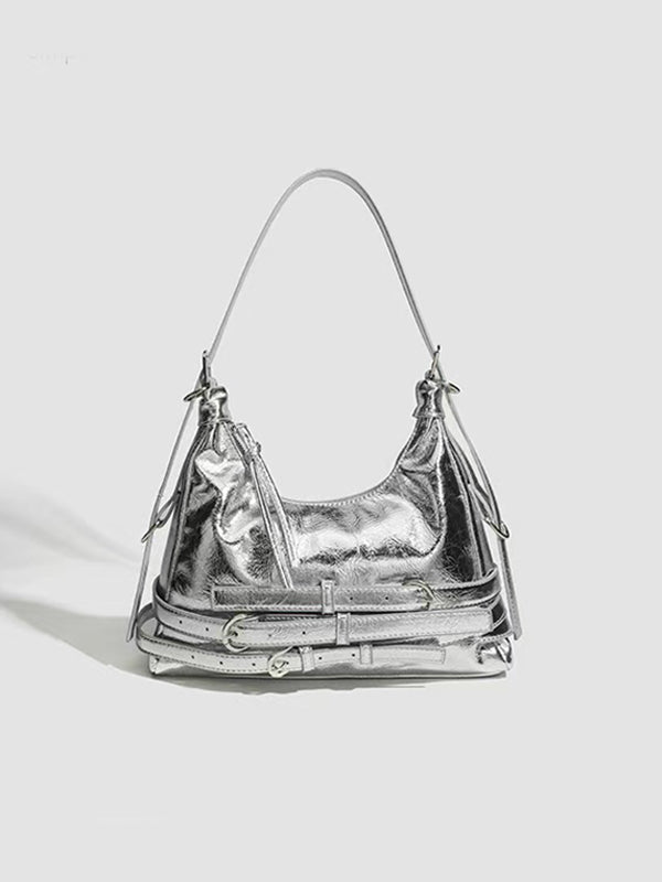 Slouchy black Y2K-inspired handbag with punk accents beside Marc Jacobs tote bag