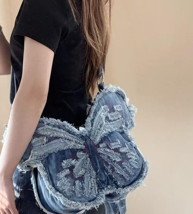 Model styling Y2K Butterfly Bag with grunge outfit and layered necklaces